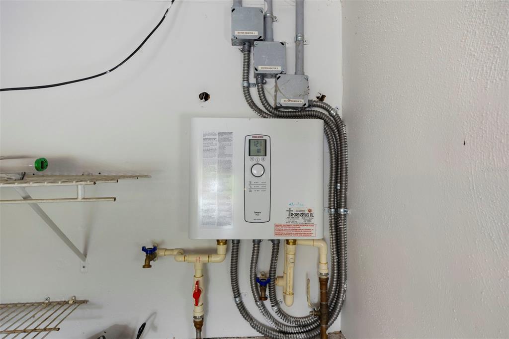 818 Eunice Drive Tarpon Springs, FL 34689 - Photo 41 of 59 a bathroom with a mirror a washer and dryer next to a window