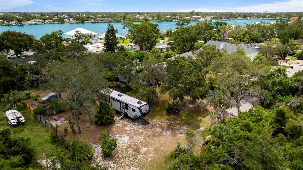 818 Eunice Drive Tarpon Springs, FL 34689 - Photo 43 of 59 an aerial view of a houses with a yard and lake view