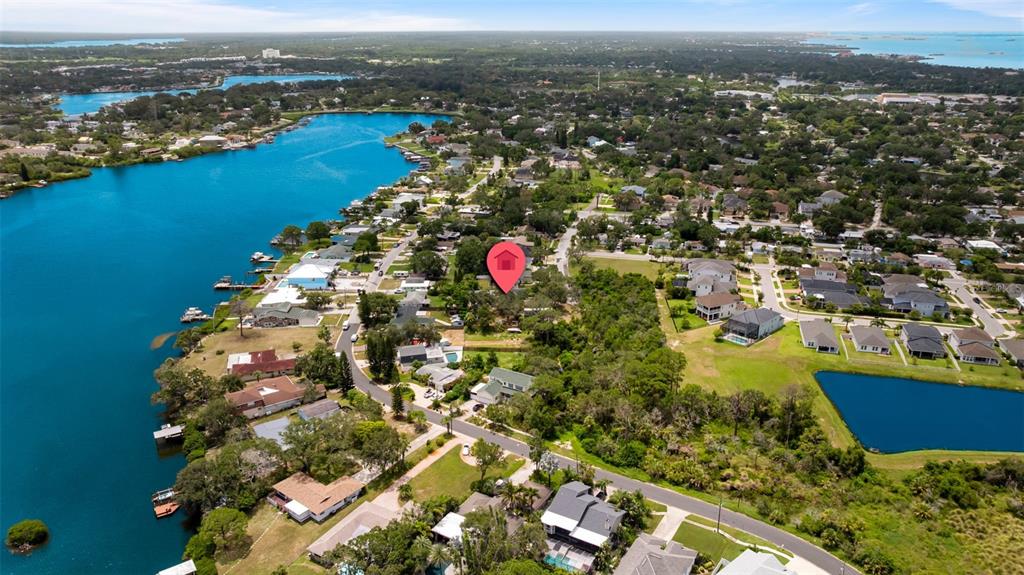 818 Eunice Drive Tarpon Springs, FL 34689 - Photo 57 of 59 an aerial view of residential houses with outdoor space and ocean view