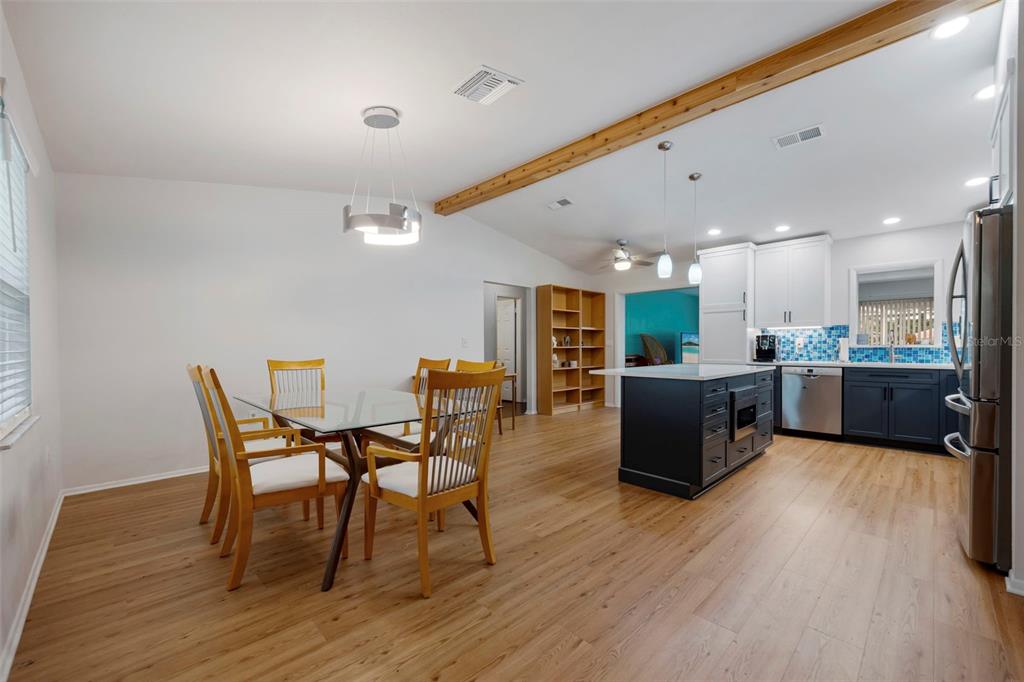818 Eunice Drive Tarpon Springs, FL 34689 - Photo 6 of 59 a view of a dining room with furniture and wooden floor