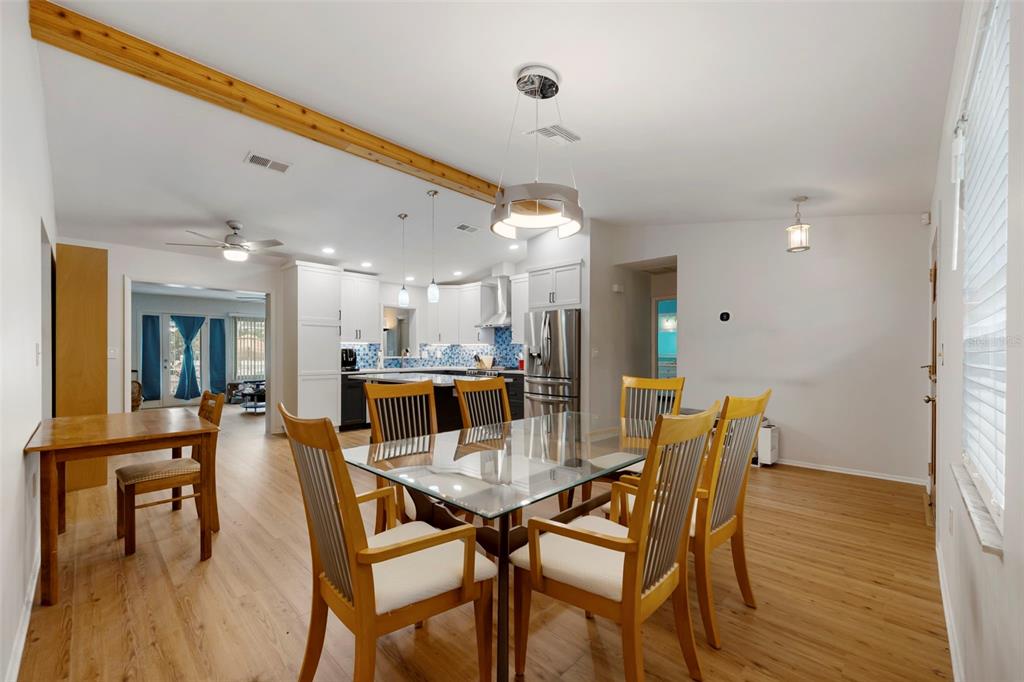 818 Eunice Drive Tarpon Springs, FL 34689 - Photo 7 of 59 a view of a dining area with furniture and wooden floor