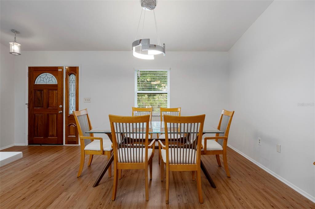 818 Eunice Drive Tarpon Springs, FL 34689 - Photo 8 of 59 a view of a dining room with furniture window and wooden floor