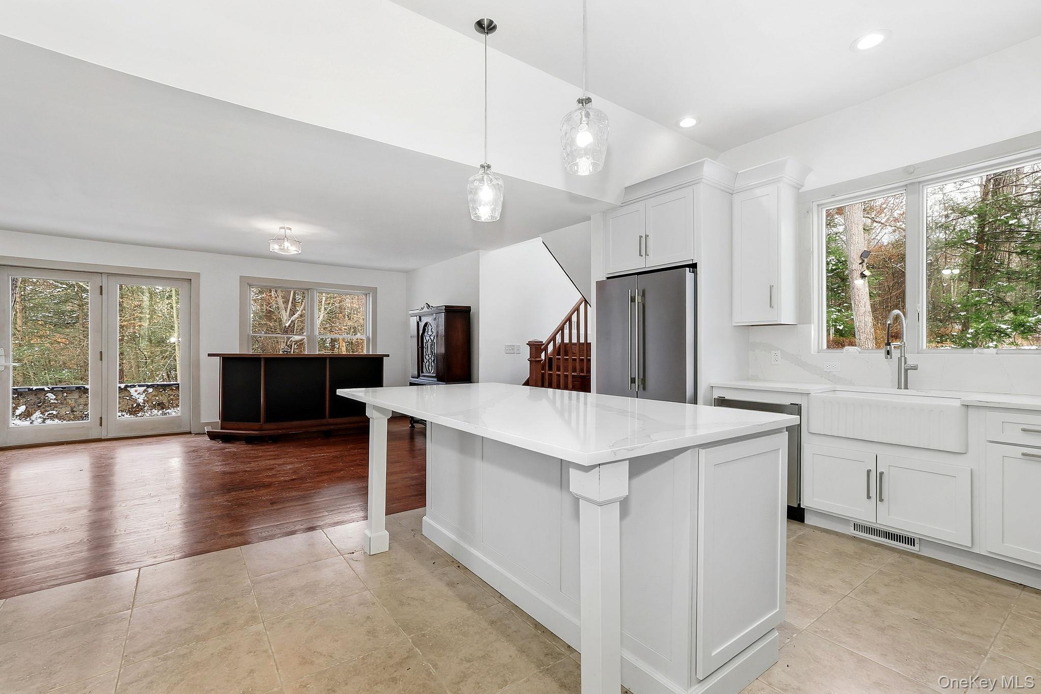 344 Schultz Hill Road Rhinebeck, NY 12572 - Photo 13 of 43 Kitchen featuring plenty of natural light, stainless steel appliances, white cabinetry, and pendant lighting