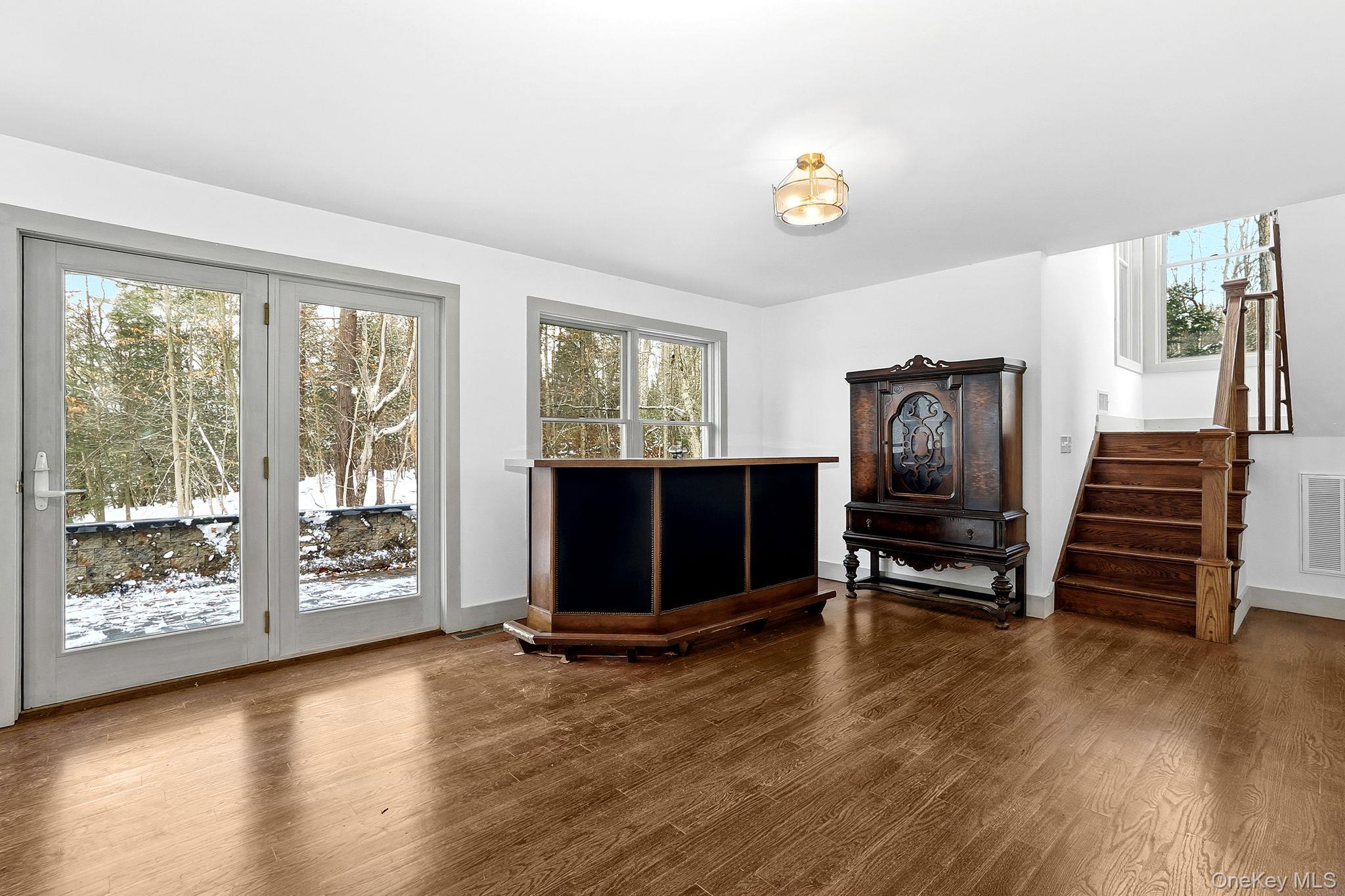 344 Schultz Hill Road Rhinebeck, NY 12572 - Photo 8 of 43 Living area featuring plenty of natural light, dark wood finished floors, and stairway