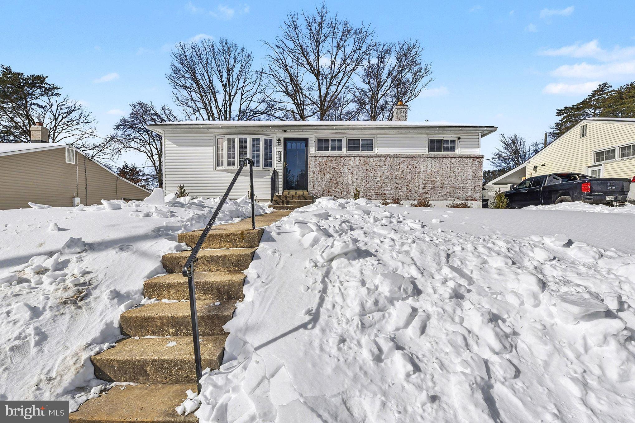 a view of a house with a snow in the backyard