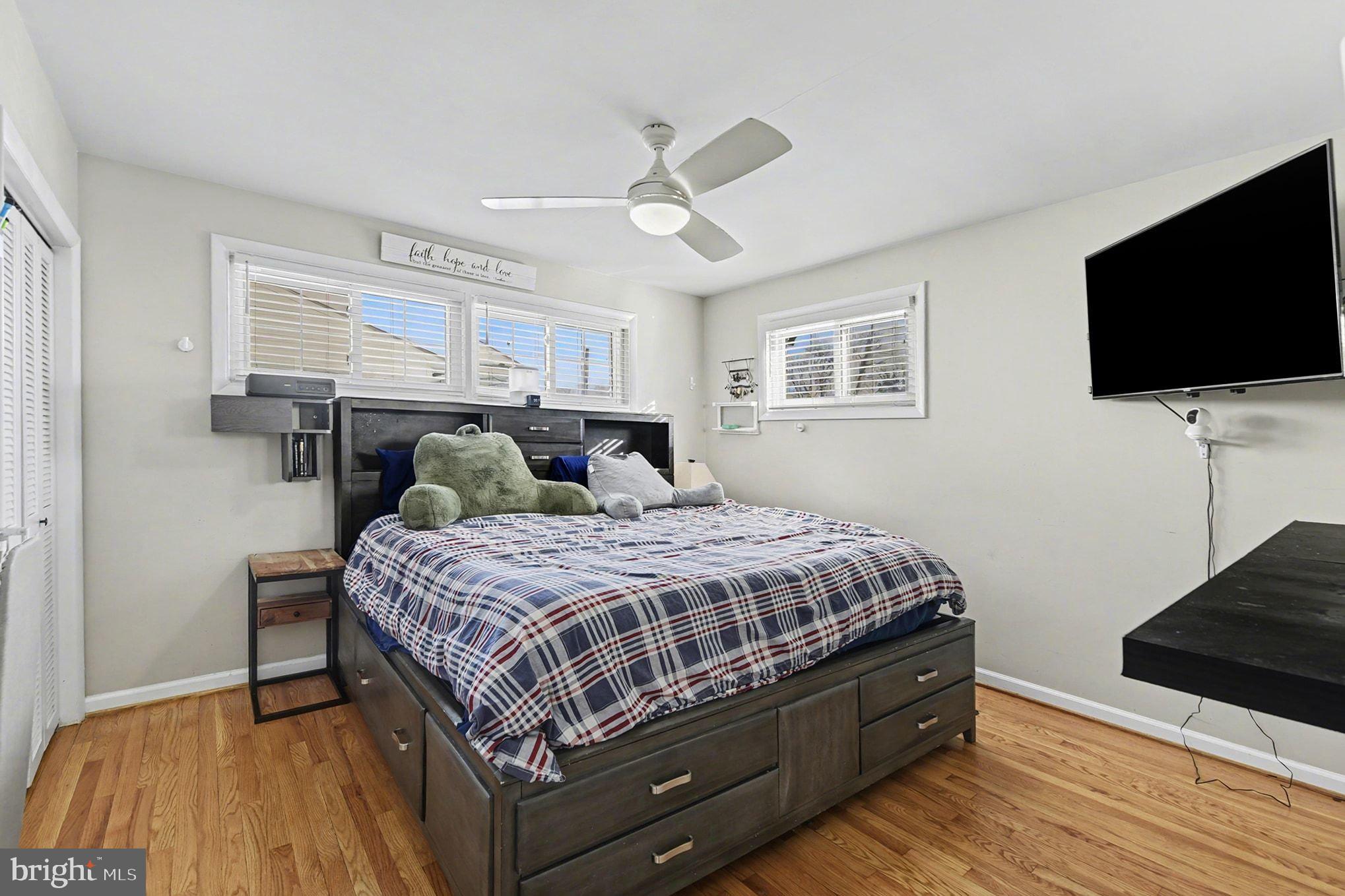 8806 Lakewood Road Parkville, MD 21234 - Photo 12 of 28 a bedroom with a bed and a flat screen tv