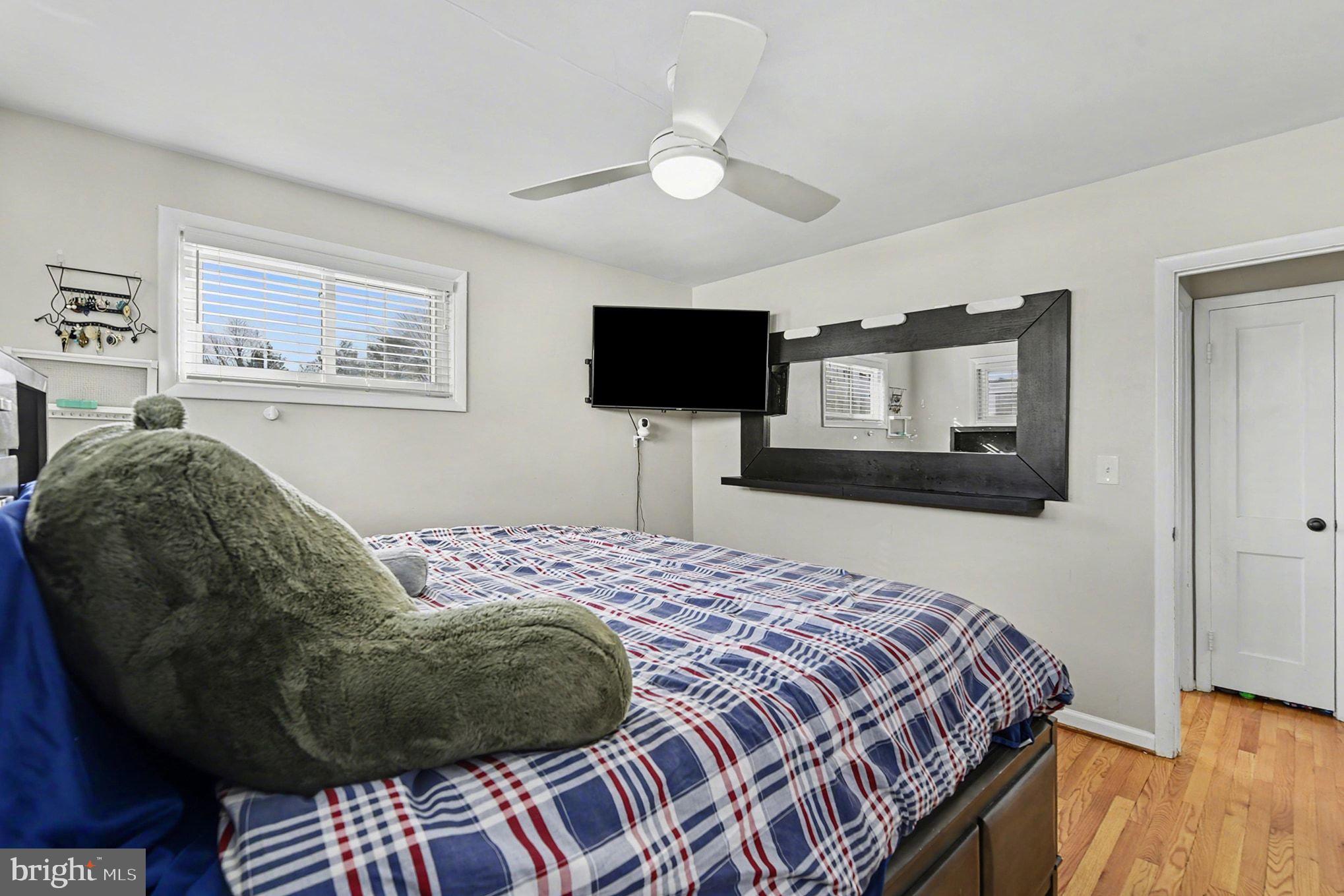 8806 Lakewood Road Parkville, MD 21234 - Photo 14 of 28 a bedroom with a bed and wooden floor