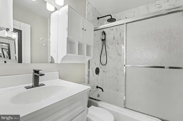 a bathroom with a sink a toilet and a shower