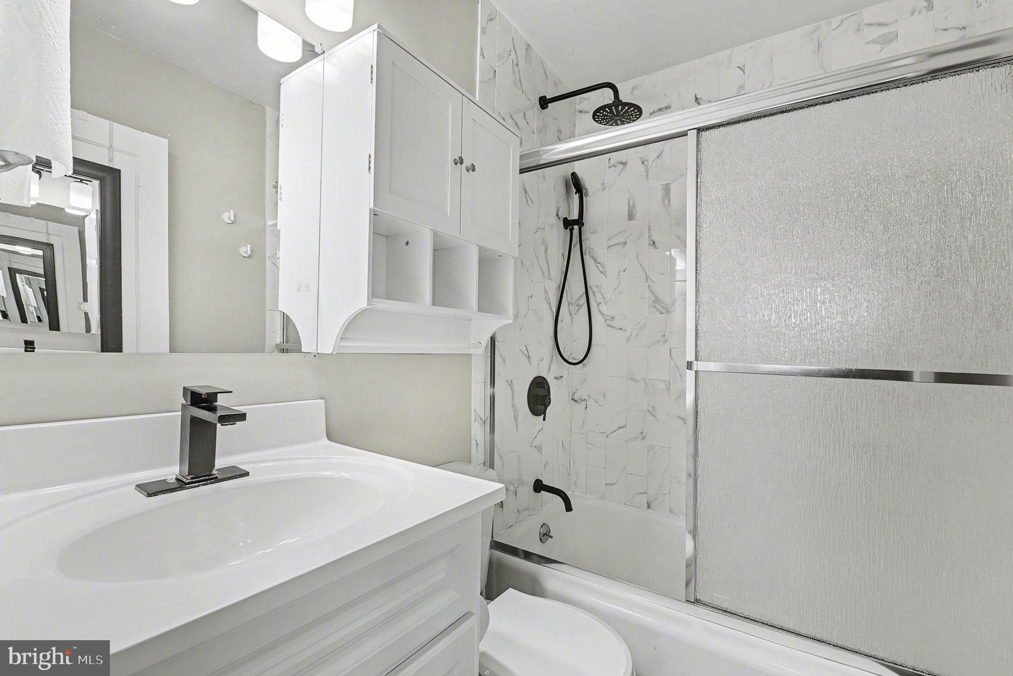 8806 Lakewood Road Parkville, MD 21234 - Photo 16 of 28 a bathroom with a sink a toilet and a shower