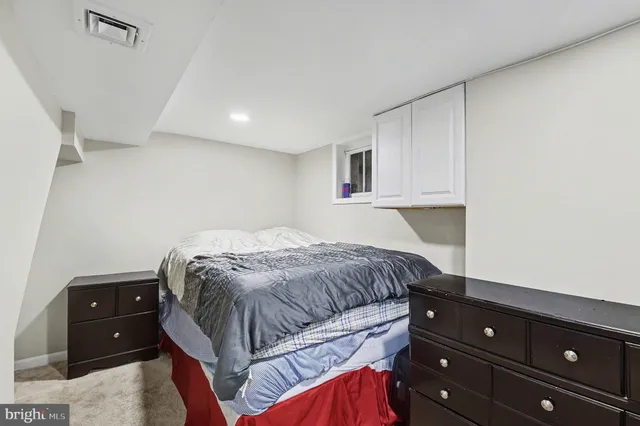 a bedroom with a bed and a cabinets