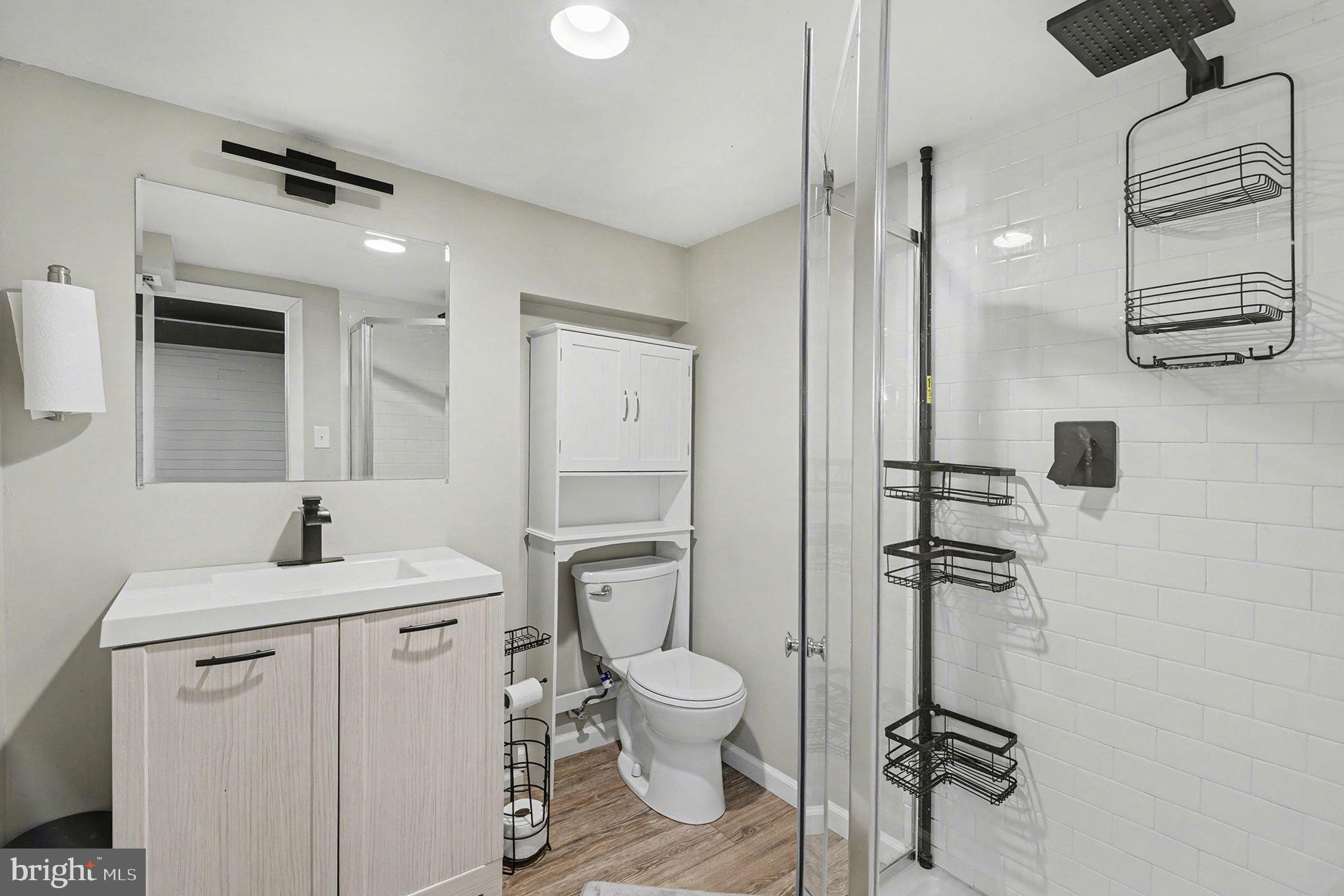 8806 Lakewood Road Parkville, MD 21234 - Photo 19 of 28 a bathroom with a sink toilet and shower