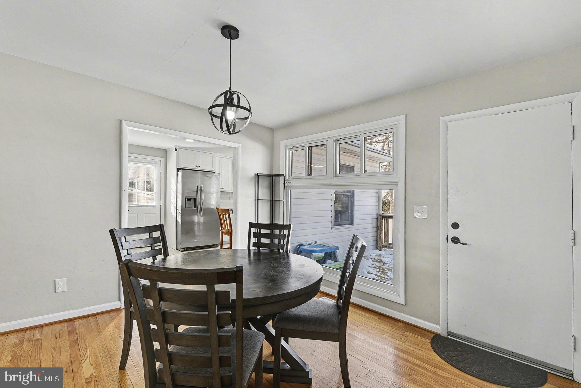8806 Lakewood Road Parkville, MD 21234 - Photo 6 of 28 a view of a dining room with furniture window and wooden floor