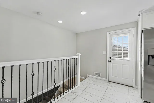 a view of a hallway with entryway door