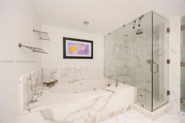 a bathroom with a bathtub and a shower