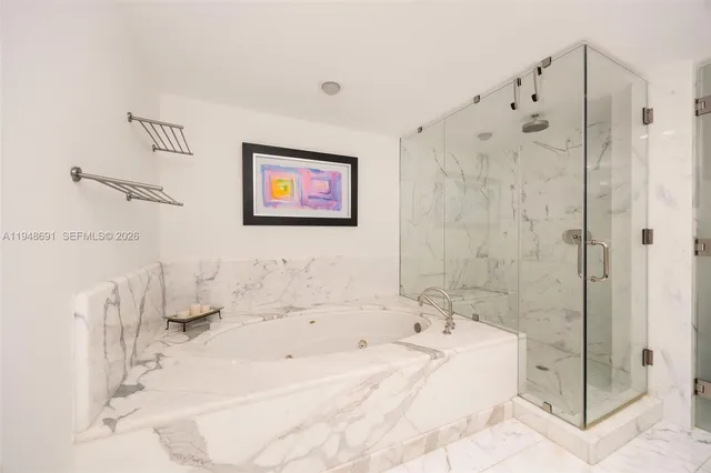 a bathroom with a bathtub and a shower