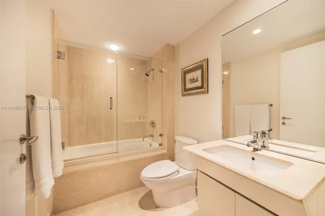 a bathroom with a sink toilet tub and shower