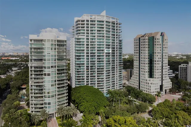 a living room with fireplace furniture and a large window