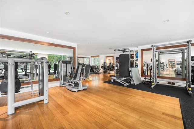 a view of a room with chairs and wooden floor