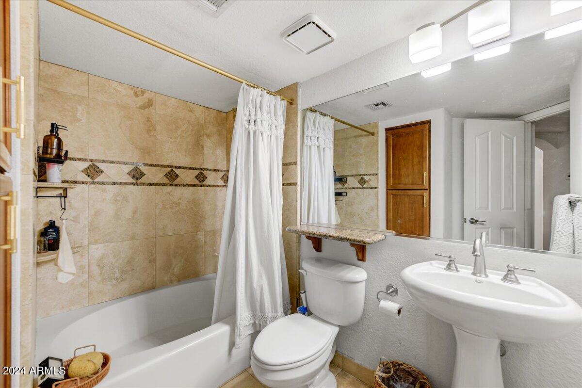 3235 East Camelback Road, Unit 109 Phoenix, AZ 85018 - Photo 11 of 20 a bathroom with a sink toilet and shower