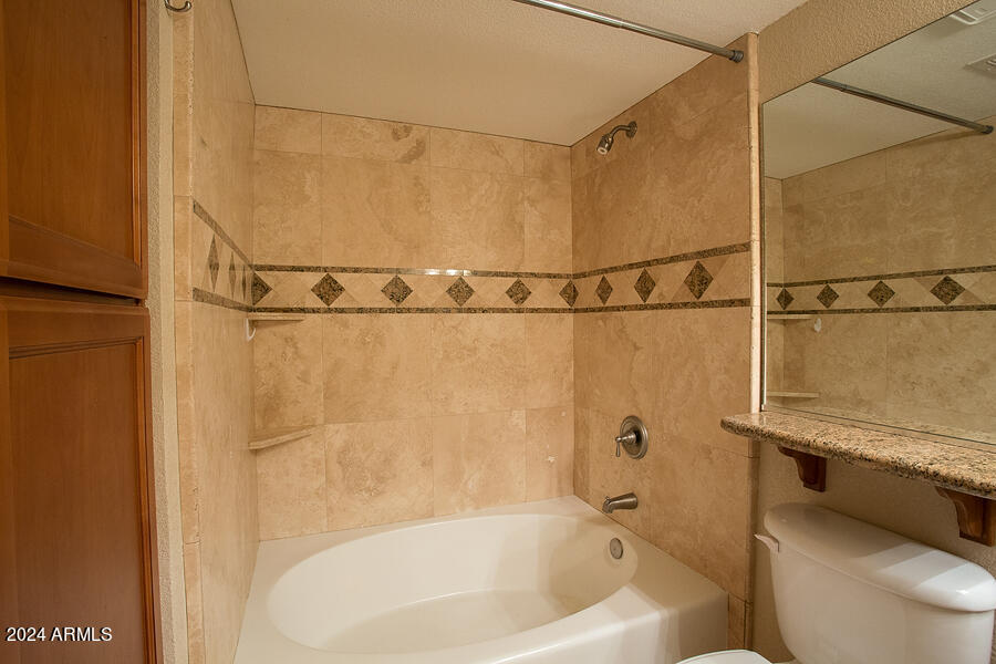 3235 East Camelback Road, Unit 109 Phoenix, AZ 85018 - Photo 12 of 20 a bathroom with a bathtub and a shower
