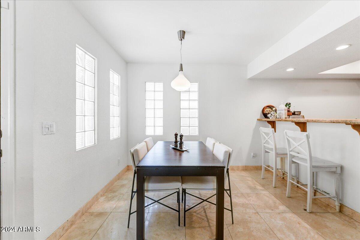3235 East Camelback Road, Unit 109 Phoenix, AZ 85018 - Photo 8 of 20 a dining room with furniture and window