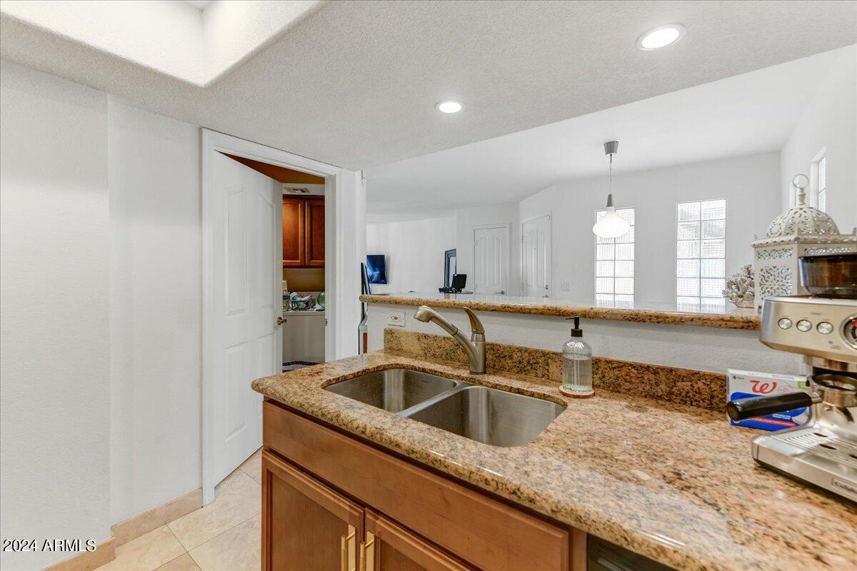 3235 East Camelback Road, Unit 109 Phoenix, AZ 85018 - Photo 10 of 20 a kitchen with a sink and a refrigerator