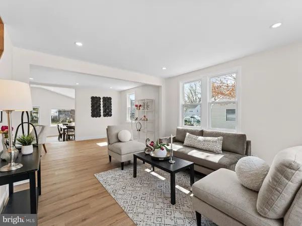 a living room with furniture a table and a window