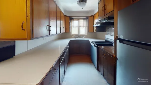 a hallway with cabinets and wooden floor