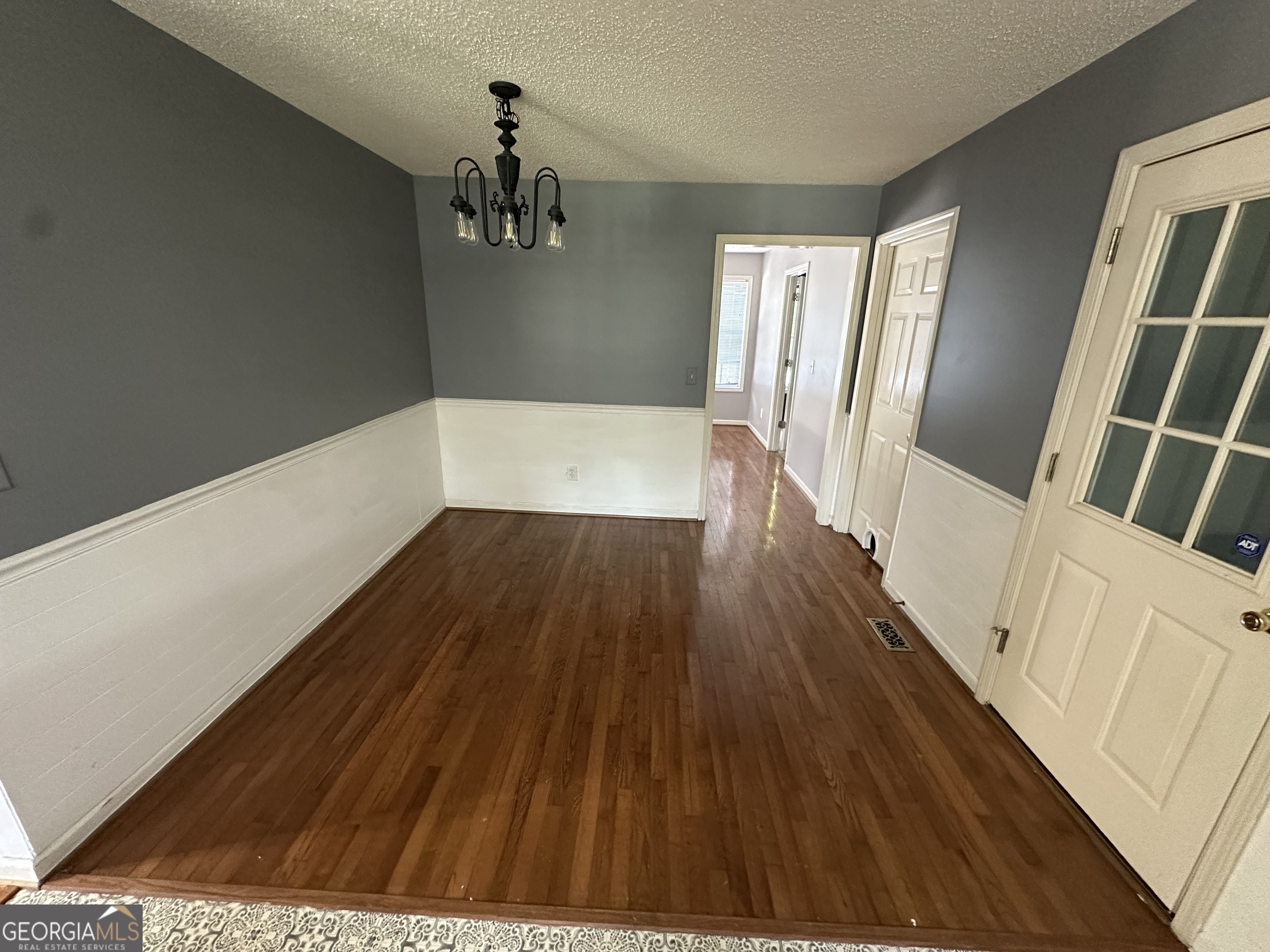 384 Sam Brown Boulevard Commerce, GA 30529 - Photo 12 of 25 a view of a hallway with wooden floor and staircase