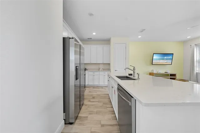 a kitchen with stainless steel appliances a refrigerator and a stove top oven