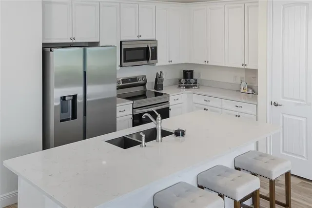 a living room with furniture kitchen view and a kitchen view