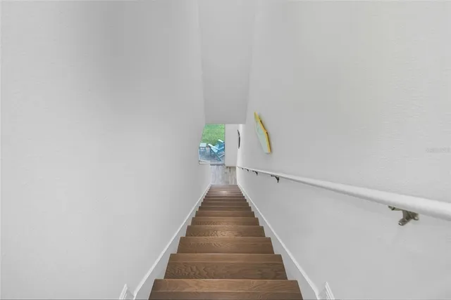 a hallway with with wooden floor and furniture