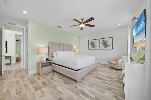 a bedroom with a large bed and a window