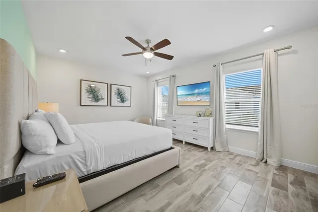 a spacious bedroom with a bed and glass window