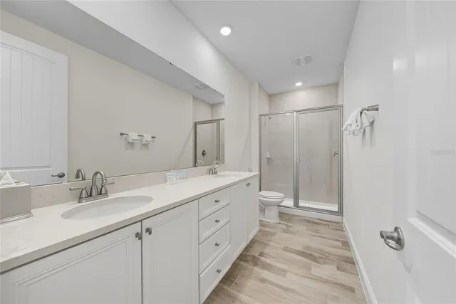 an aerial view of multiple houses with a yard