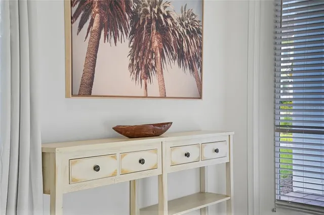 a kitchen with a dining table chairs refrigerator and cabinets