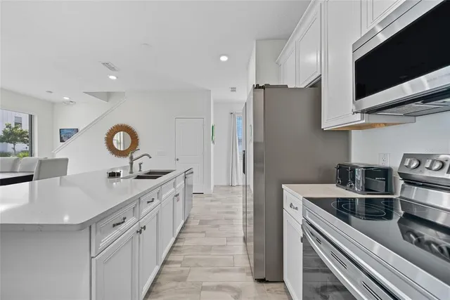 a kitchen with a sink appliances and cabinets