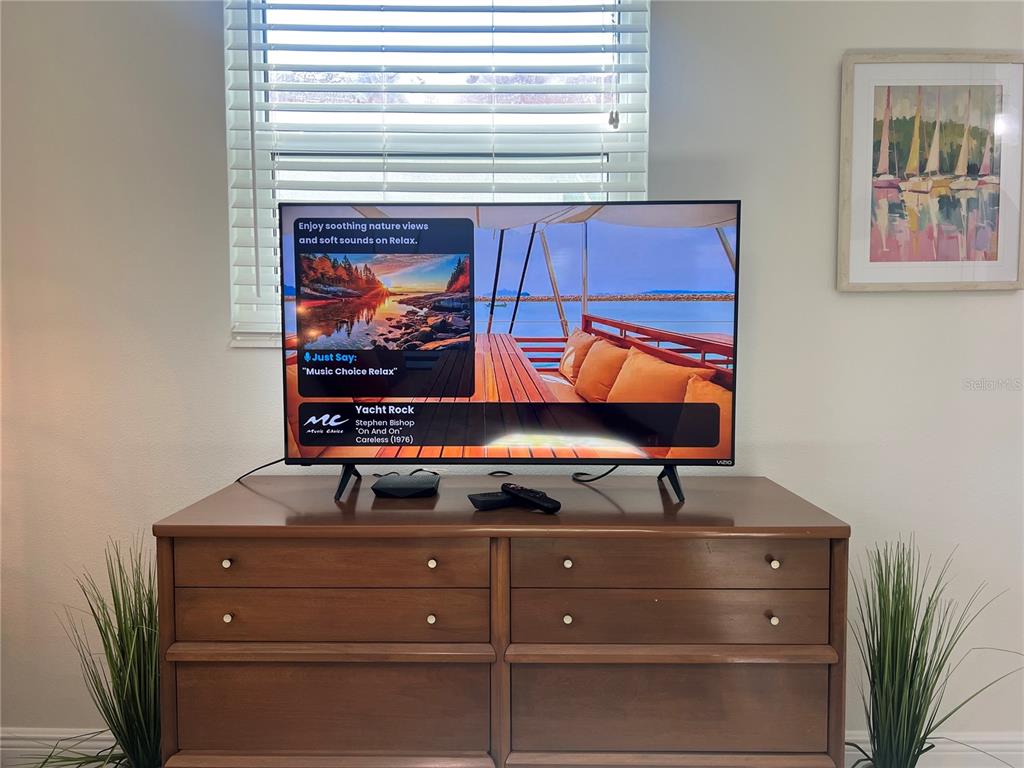 6154 Midnight Pass Road, Unit B16 Sarasota, FL 34242 - Photo 12 of 14 a room with furniture and mirror