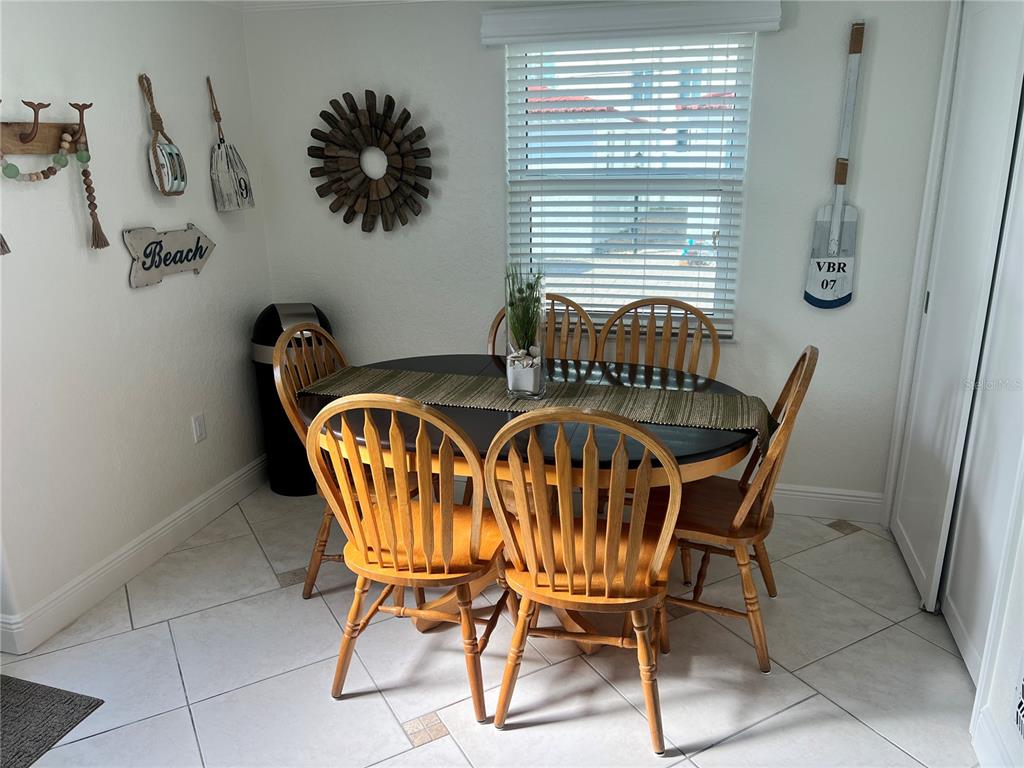 6154 Midnight Pass Road, Unit B16 Sarasota, FL 34242 - Photo 2 of 14 a view of a dining room with furniture and window