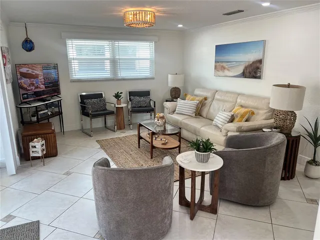 a living room with furniture a air conditioner and a window