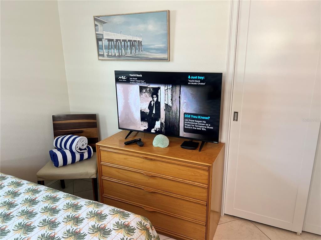 6154 Midnight Pass Road, Unit B16 Sarasota, FL 34242 - Photo 8 of 14 a bedroom with a bed and a dresser