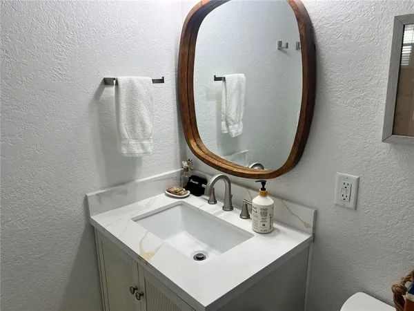 a bathroom with a sink and a mirror