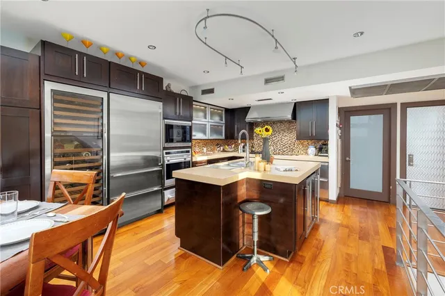 a kitchen with stainless steel appliances kitchen island granite countertop a sink and cabinets