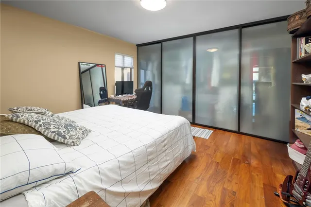 a large bed sitting in a bedroom next to a glass door shower