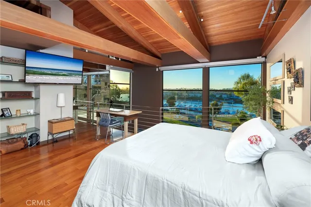 a bed room with a bed and large windows