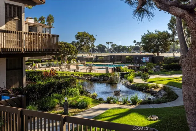 a view of a swimming pool with a patio and a garden