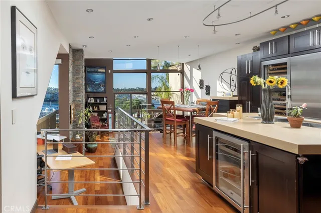 a kitchen with a sink and wooden floor