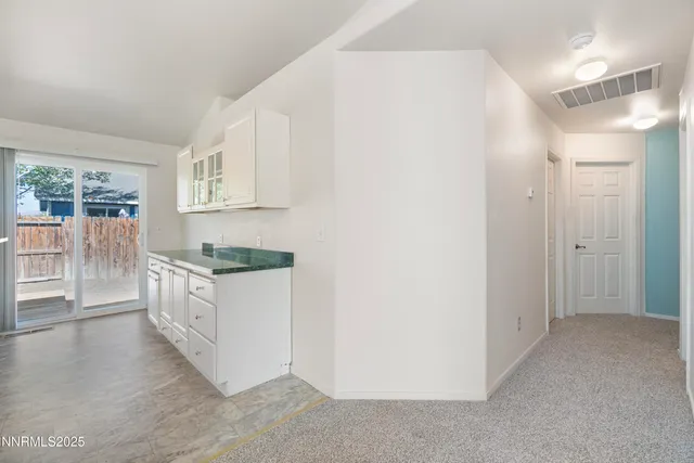 a kitchen with a refrigerator and a stove