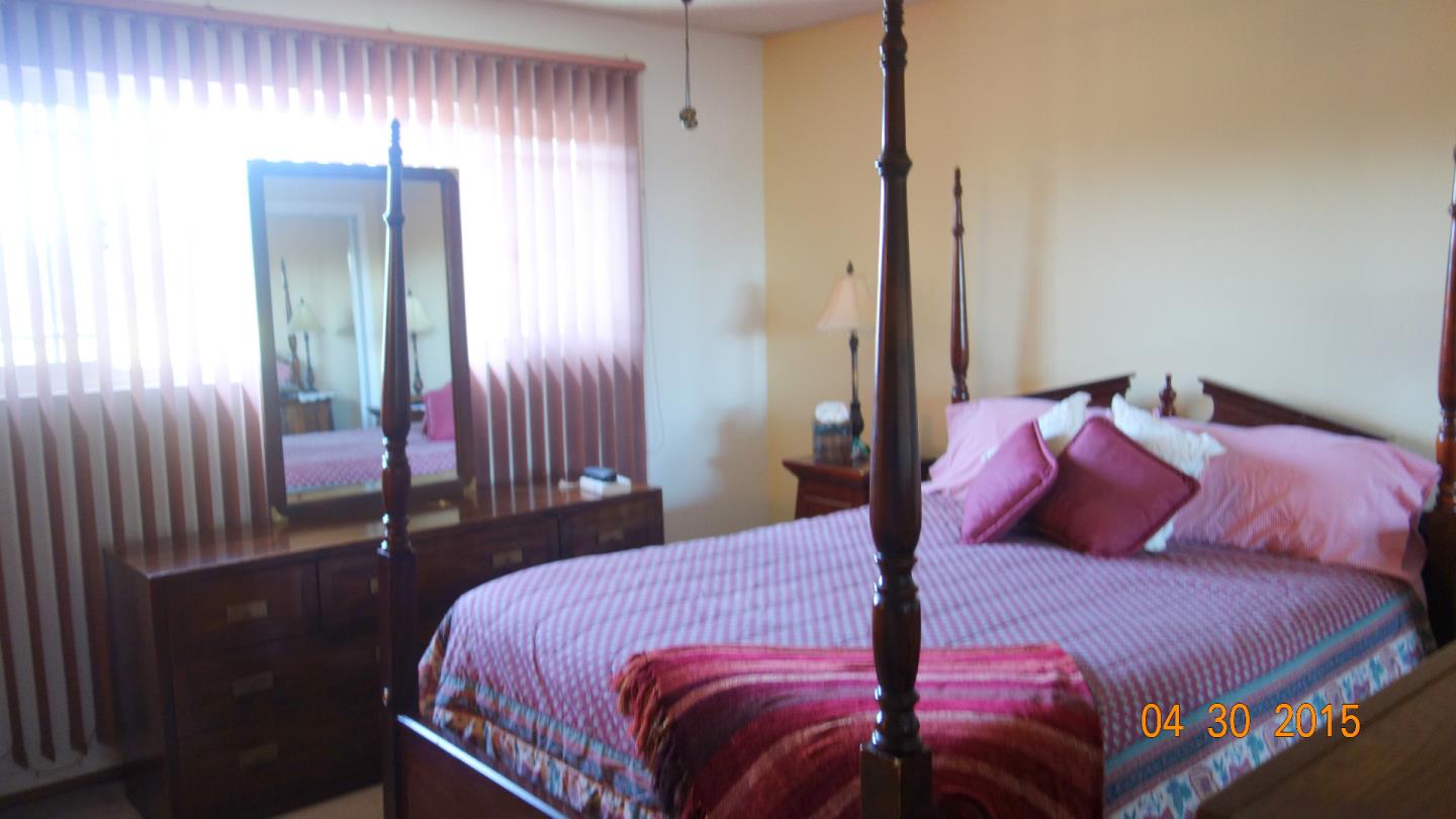 775 Graham Hill Road Santa Cruz, CA 95060 - Photo 8 of 17 a bedroom with a bed and a mirror