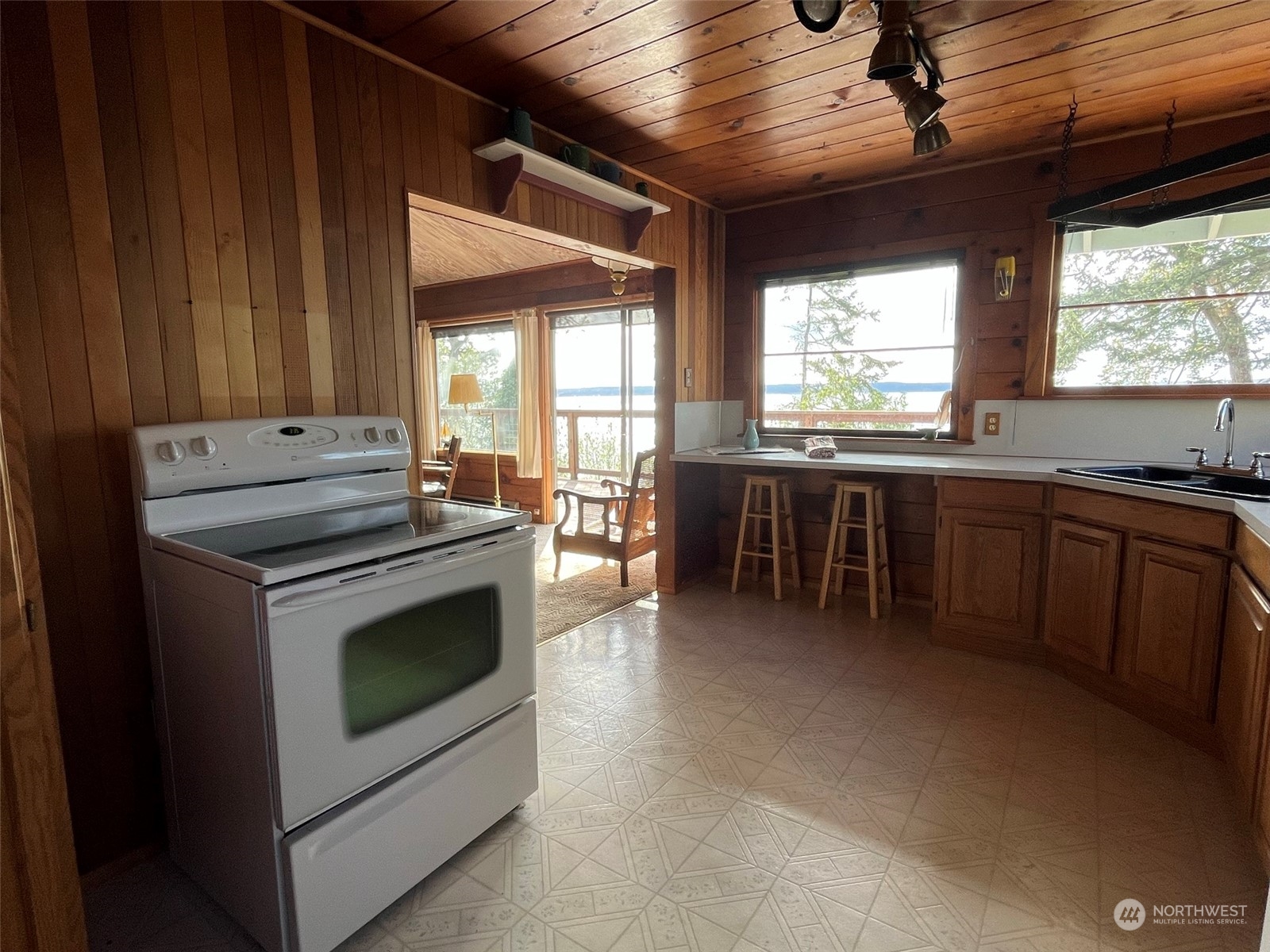 509 Spring Street Camano Island, WA 98282 - Photo 12 of 28 a kitchen with stainless steel appliances granite countertop a stove a sink and a microwave